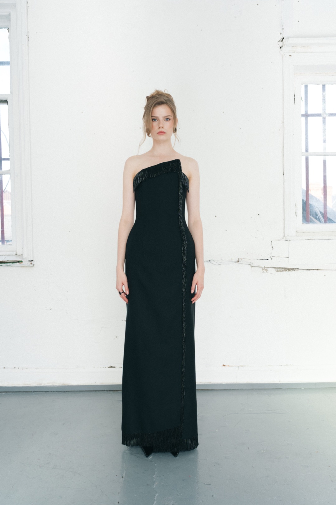 The fringe gown, full length from the front, fringe at neckline, split and hem