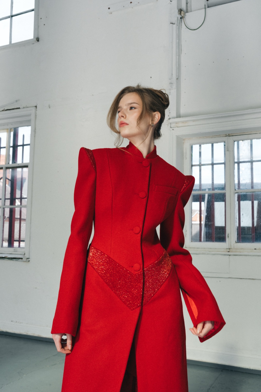 The red coat, three-quarter length, turning, beaded chevron at the waist
