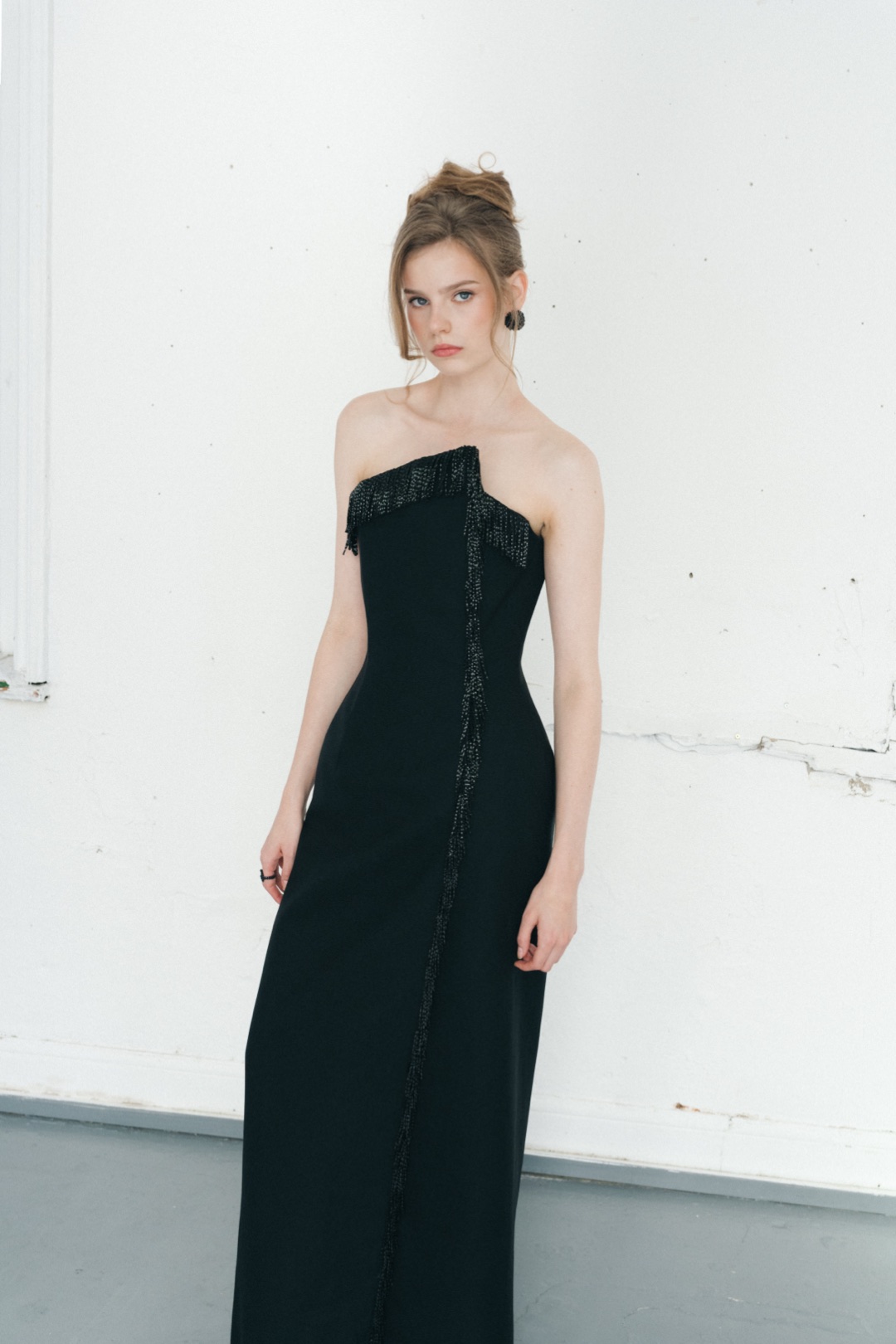 The fringe gown, to the knee, fringe running from the neckline down the split