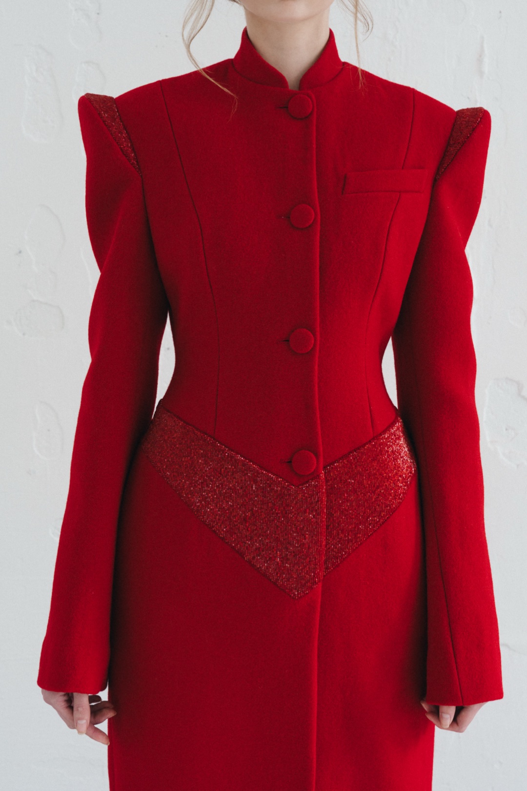 The red coat, close-up of the bodice with beaded shoulders and waist chevron
