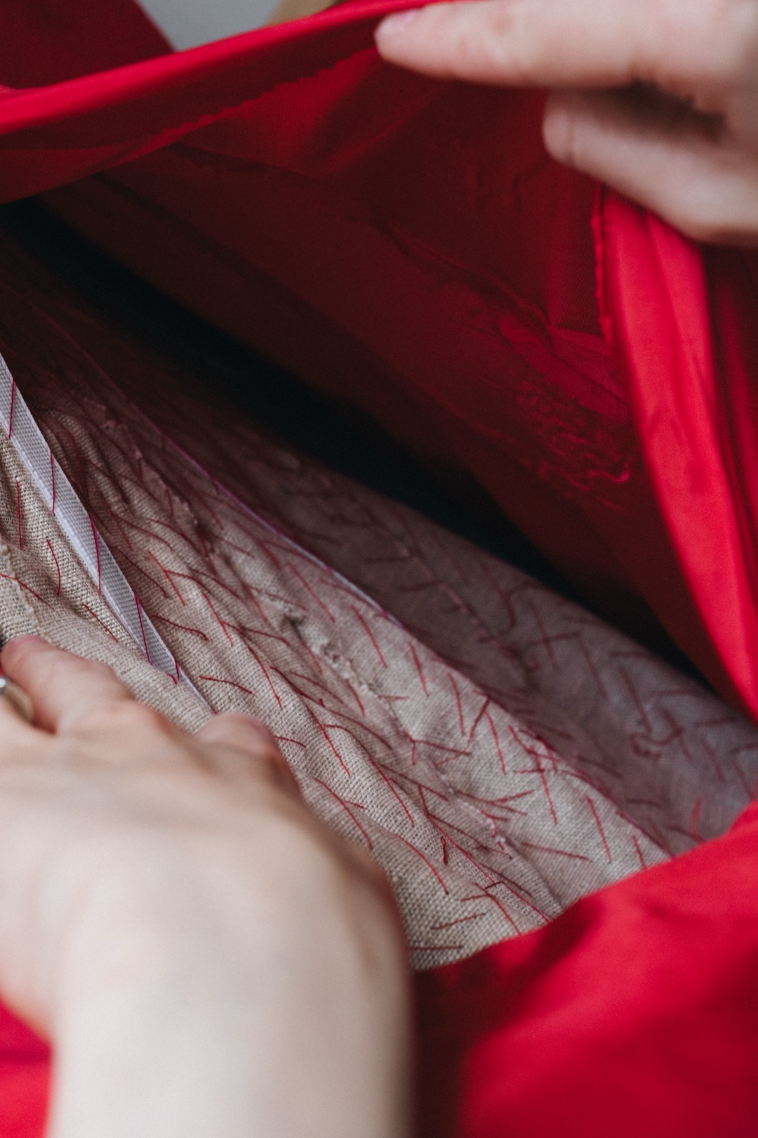 The red mini, lining lifted to show canvas pad-stitched in red thread