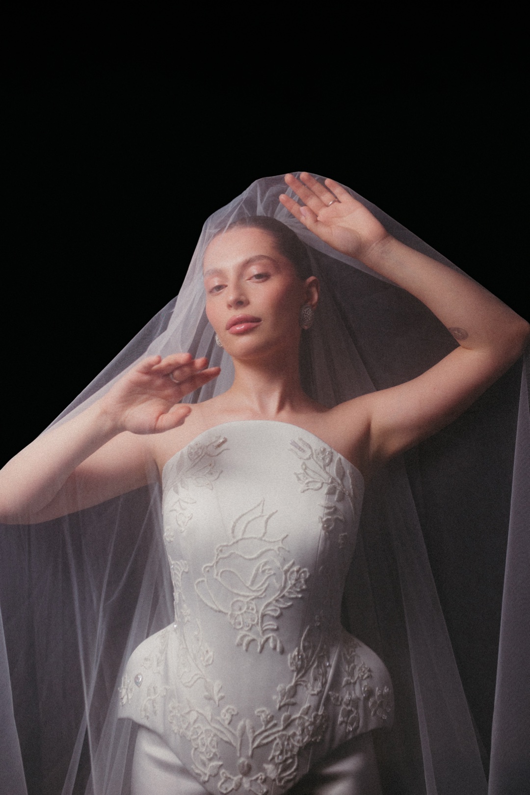 The ceremony gown under a long veil