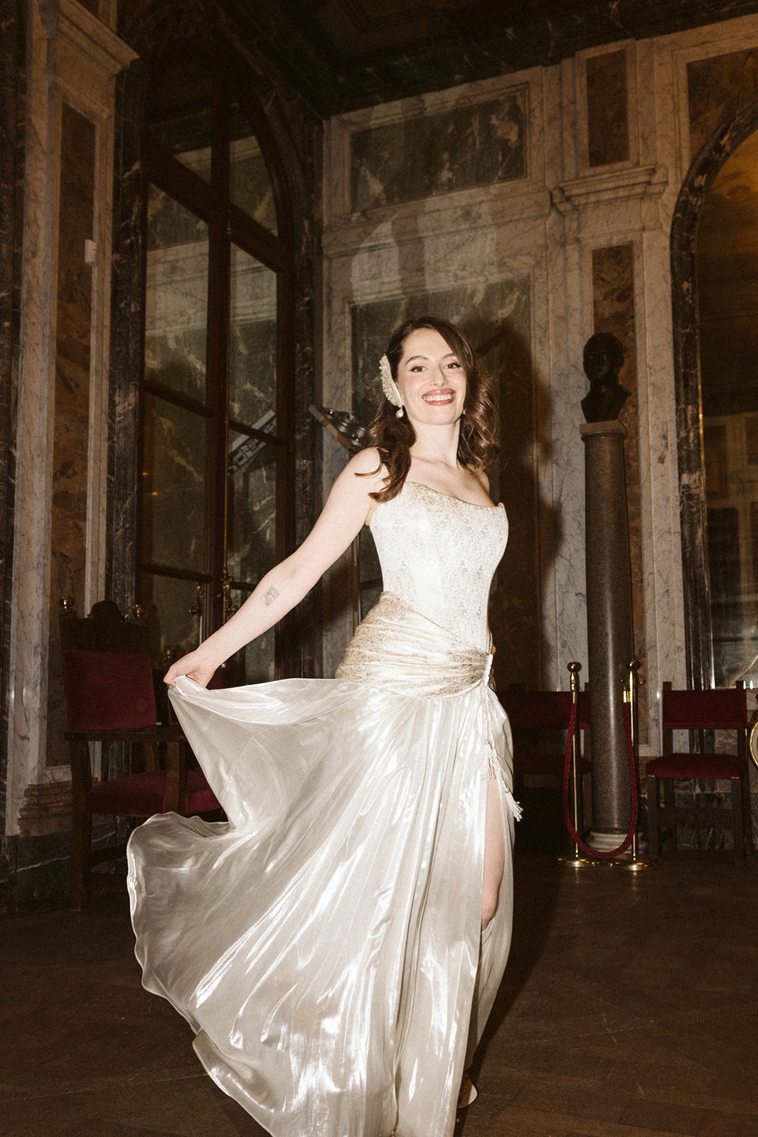 Dancing in the evening gown beneath a chandelier